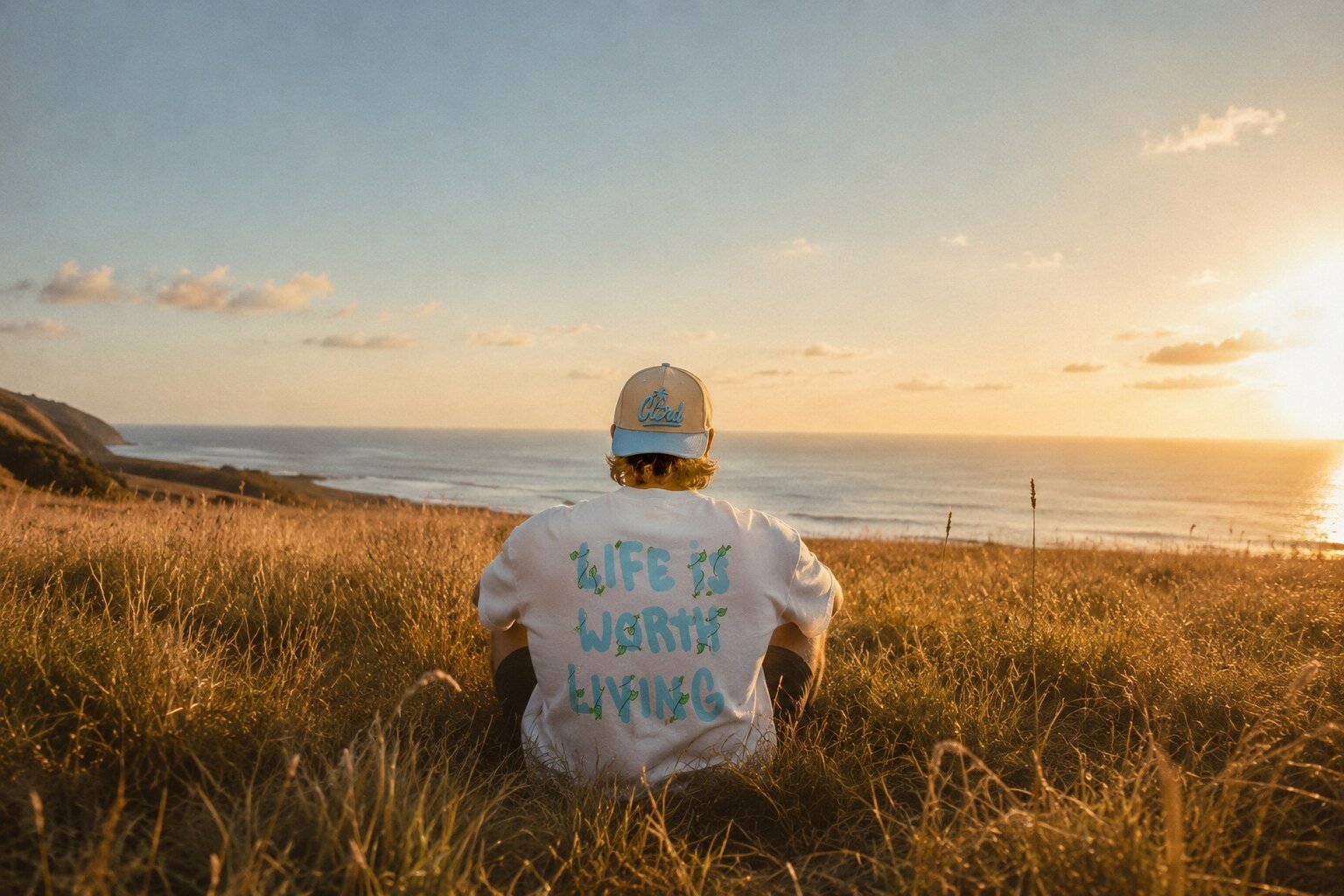 Cultured Apparel — Dubai streetwear brand, model in Summer Archive tee at sunset